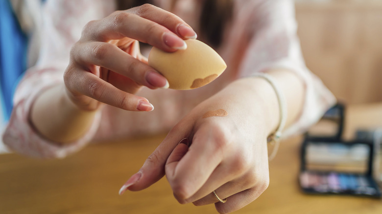 Woman applying foundation