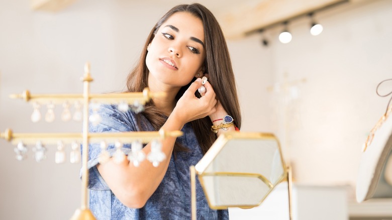 Woman trying on earrings