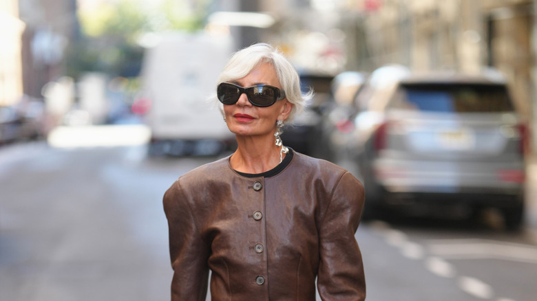 Grece Ghanem wearing a shoulder-padded blazer and bold black sunglasses
