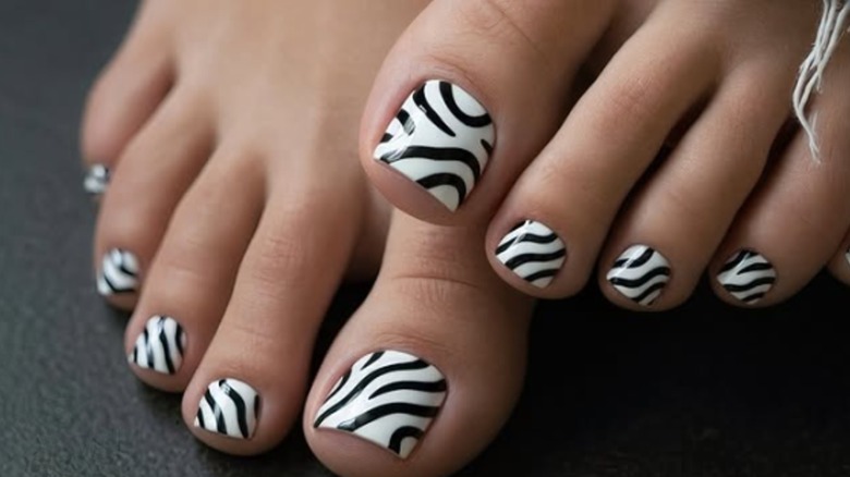 A pedicure with a zebra print nail polish design