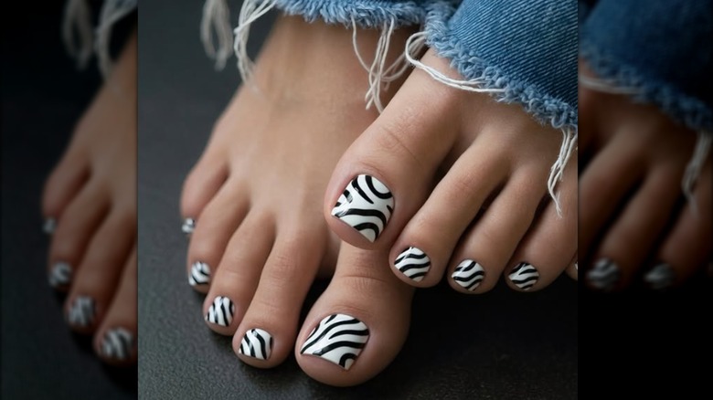 A pedicure with a zebra print nail polish design