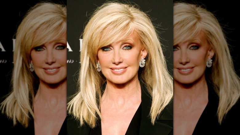 Morgan Fairchild at an event in 2009 with smooth hair wearing black.