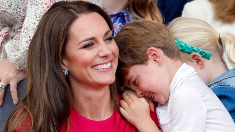 Prince Louis laughs on mom Kate Middleton's shoulder