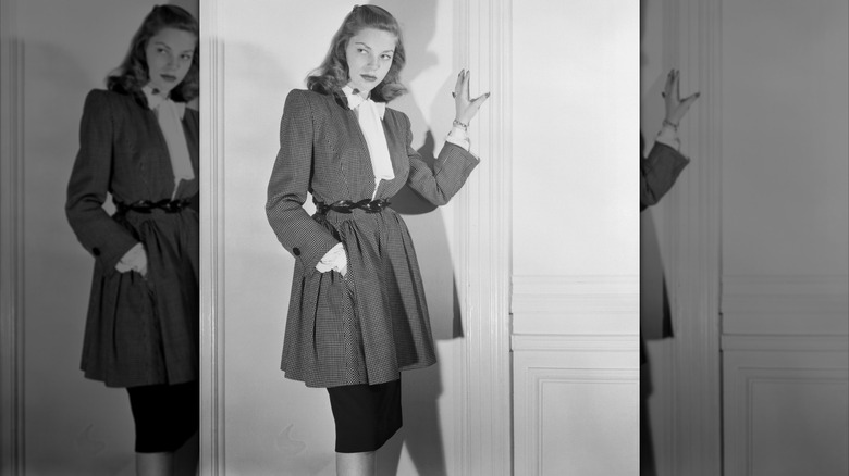Lauren Bacall wearing a Nettie Rosenstein checkered coat and pencil skirt in a promo shot in February 1945
