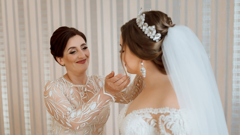 Mother helping a bride get ready