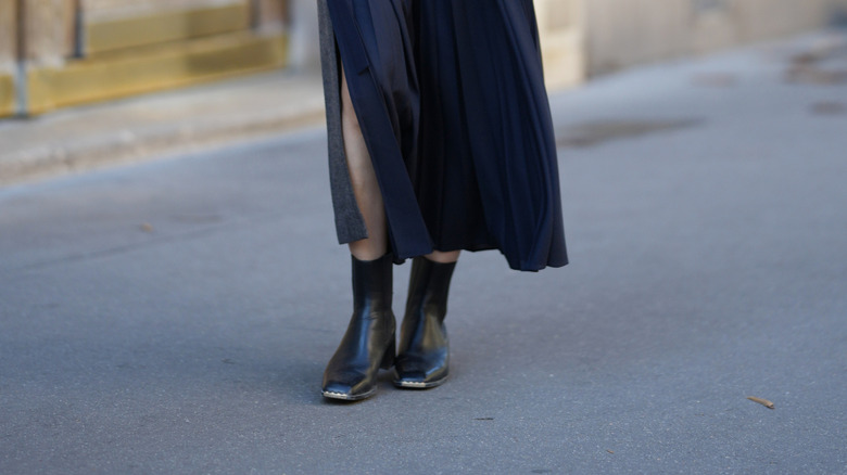 Woman wearing slim black boots