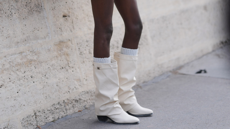Woman wearing white boots