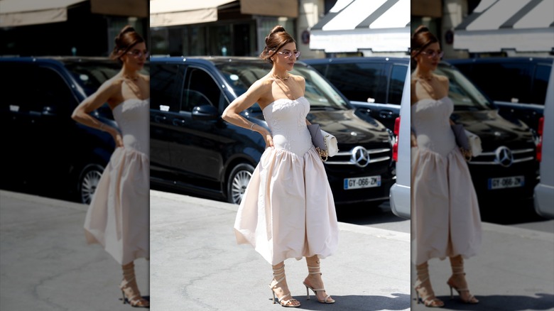 A person wearing a dress with a Basque waist