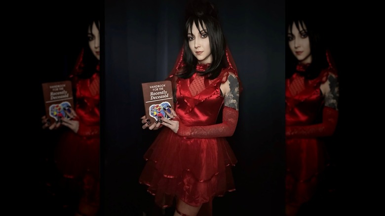 A woman wears a short Lydia Deetz costume from "Beetlejuice"