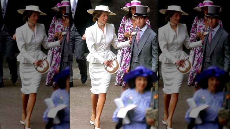 Princess Diana pictured in 1986 wearing a white cinched blazer, skirt, and hat