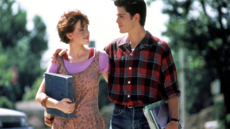 Molly Ringwald wearing a pink floral-print dress over a pink t-shirt in "Sixteen Candles."