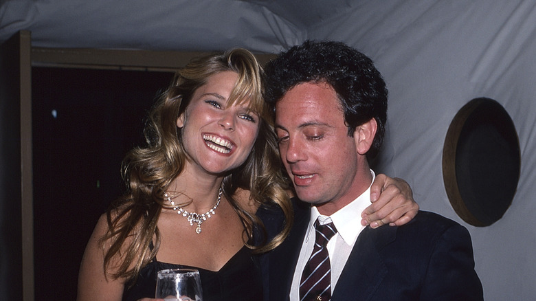 Christie Brinkley with her arm around Billy Joel in the '80s