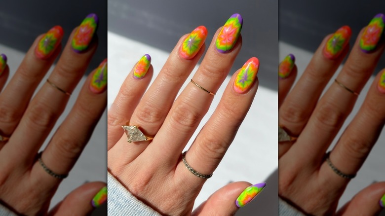 A close up picture of a colorful tie-dye manicure.