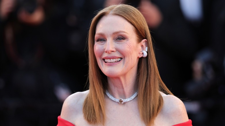 Julianne Moore wore her red straight hair down with a middle part and a strapless red gown while attending the 79th Annual Cannes Film Festival in Cannes, France in 2026.