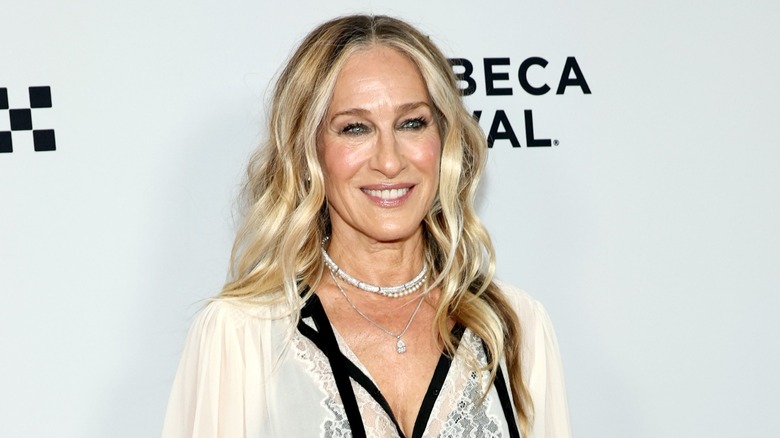 Sarah Jessica Parker wore a middle part and her golden blond hair in relaxed waves along with a beige lacy blouse at the 2026 Tribeca Festival in New York City.