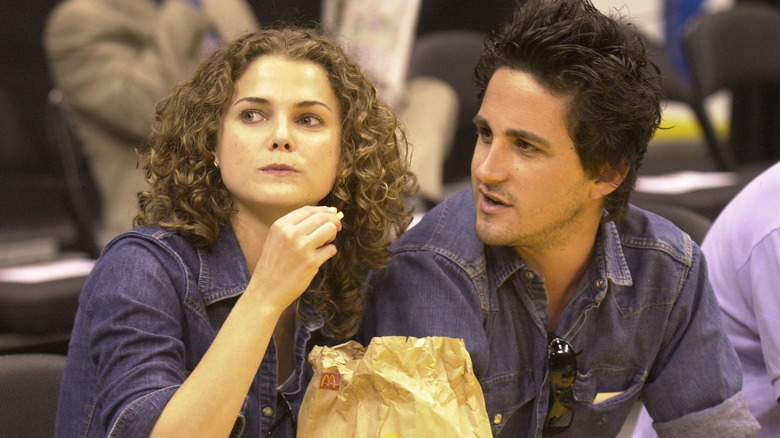Keri Russell enjoys some french fries with a friend during NBA playoff game between the Sacramento Kings and the Los Angeles Lakers May 6, 2001