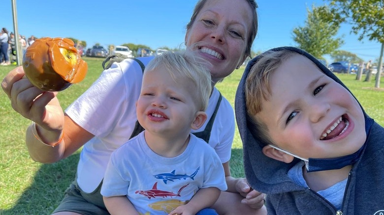 Dylan Dreyer posing with her sons and a caramel apple