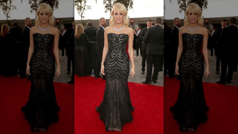 Carrie Underwood poses wearing a strapless black gown