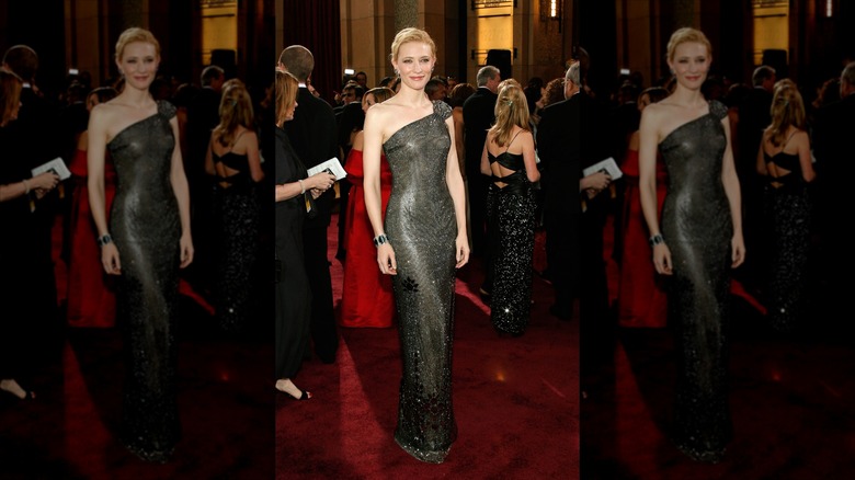 Cate Blanchett smiles wearing a black one-shoulder embellished dress