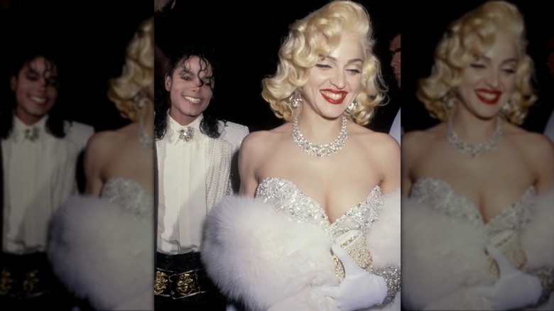 Madonna wearing an encrusted white gown next to Michael Jackson