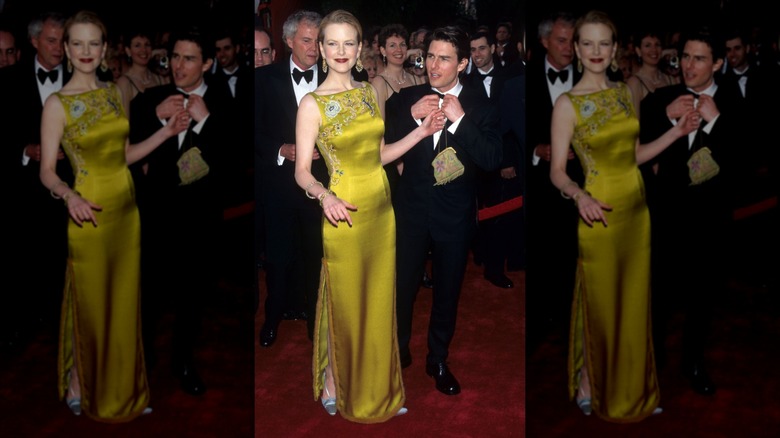 Nicole Kidman smiles wearing a green satin dress next to Tom Cruise