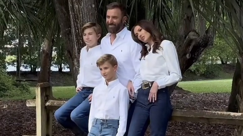Dustin Johnson, Paulina Gretzky, Tatum Johnson, and River Johnson, posing for a photo in matching outfits.