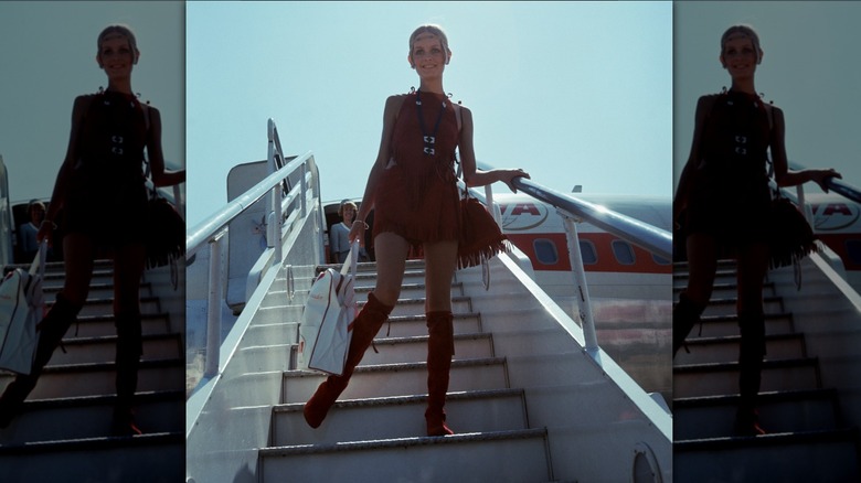 Twiggy exiting a plane in London in 1965