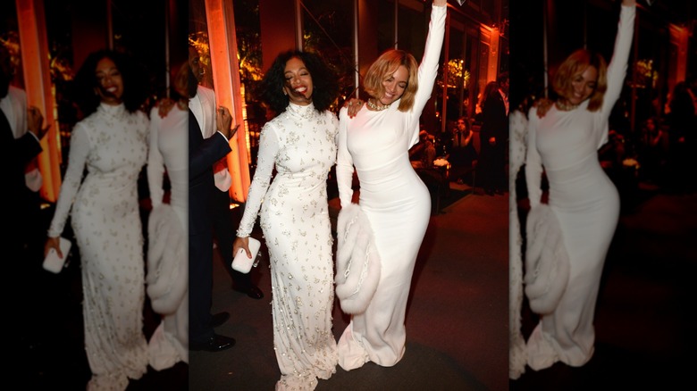 Beyoncé and Solange Knowles wearing white gowns at the 2015 Vanity Fair Oscar Party