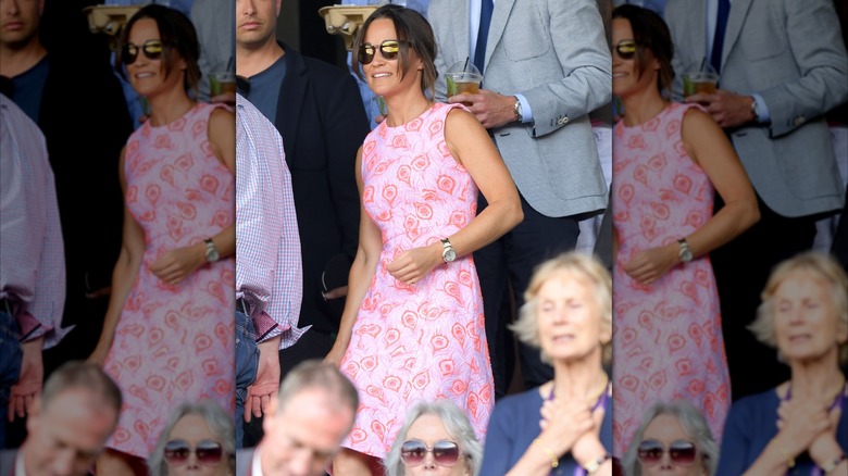 Pippa Middleton wearing a pink dress with peacock-feather print and sunglasses at Wimbledon in 2016.