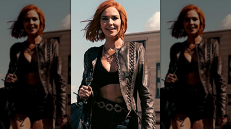 Belle Skinner wearing black mini shorts and a leather jacket