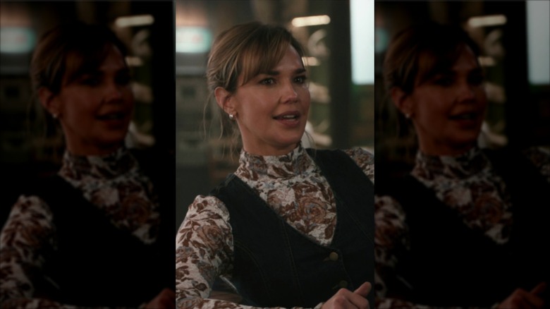 Belle Skinner wearing a floral turtleneck and waistcoat