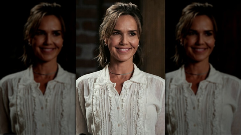 Belle Skinner wearing a ruffled shirt