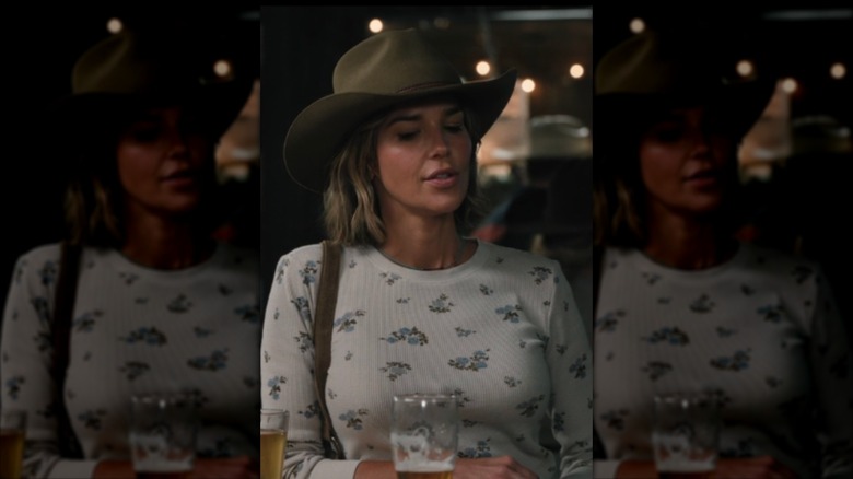 Belle Skinner wearing a floral top and a cowboy hat