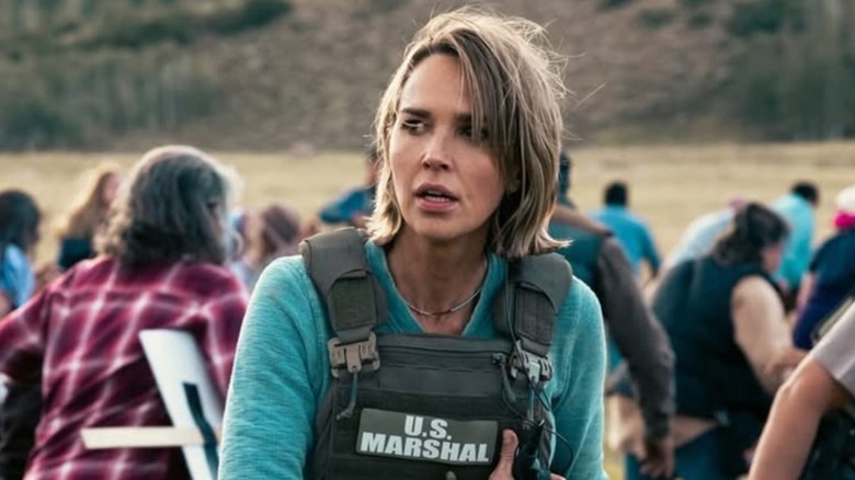 Belle Skinner wearing a turquoise shirt and a bullet-proof vest