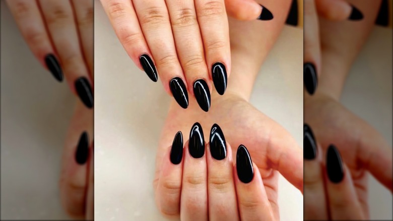 An almond manicure with jet black nail polish