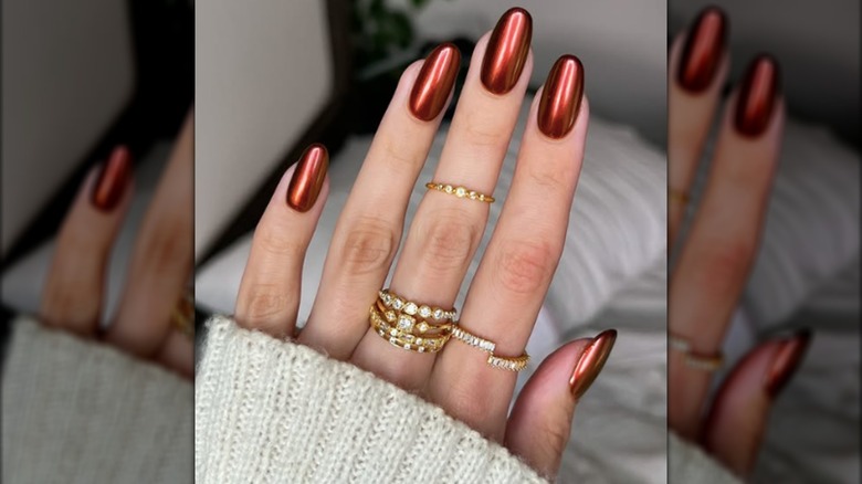 A round manicure with chrome copper nail polish