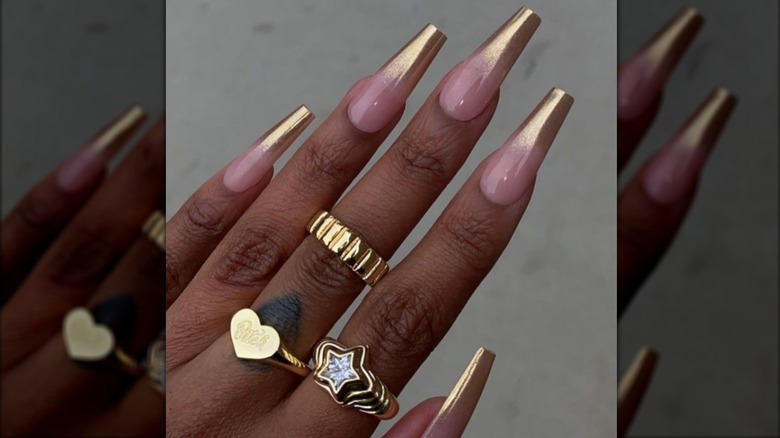 A long french manicure with gold chrome tips