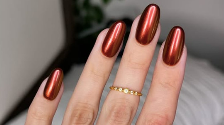 A manicure with burnt cinnamon chrome nail polish