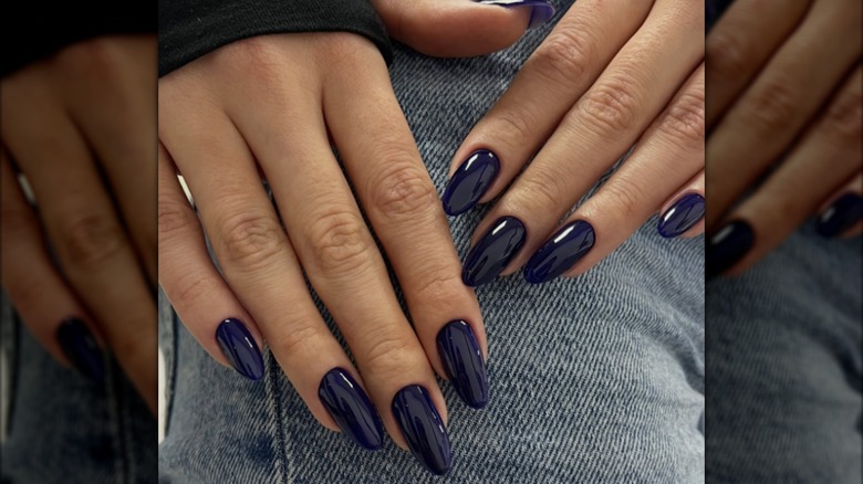 An almond manicure with midnight blue nail polish