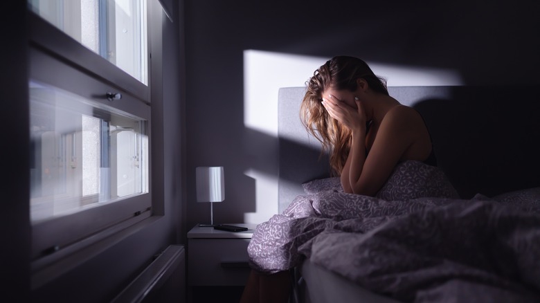 woman upset in bed