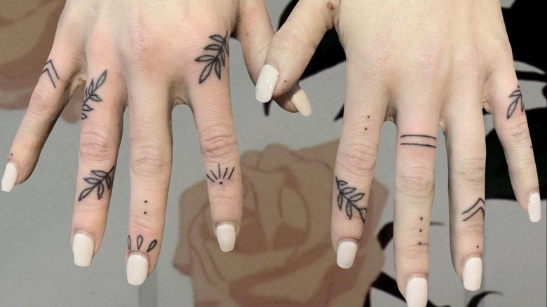 hands with finger tattoos