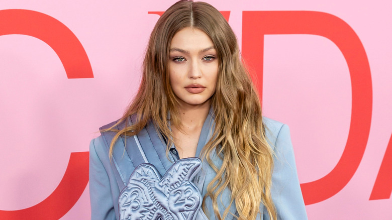 Gigi Hadid pictured with long hair wearing a blue blazer.