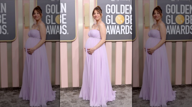 Kaley Cuoco holds onto her baby bump wearing a lavender gown