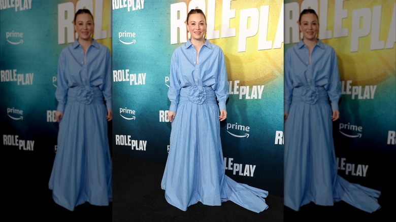 Kaley Cuoco smiles wearing a pinstripe shirt dress in baby blue