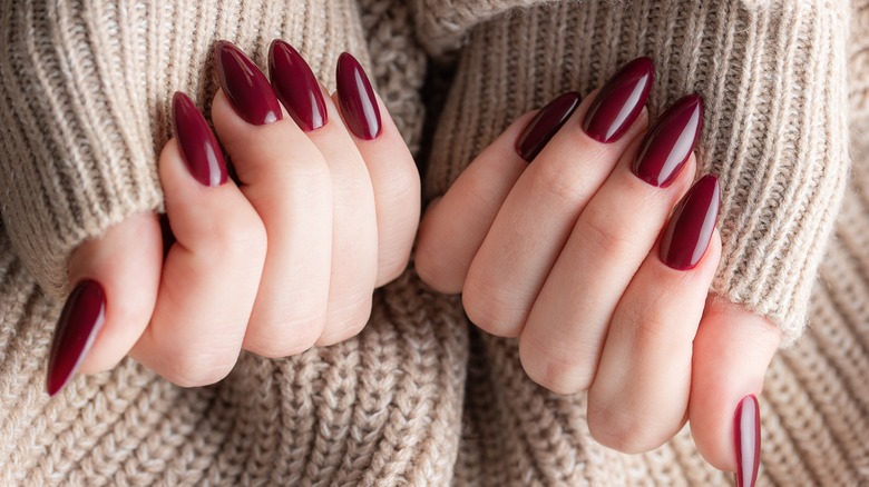burgundy colored manicured nails