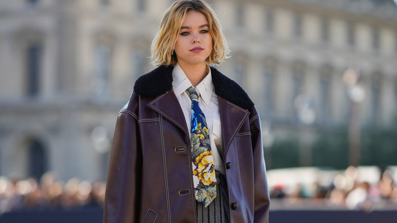 woman wearing necktie with white top and jacket