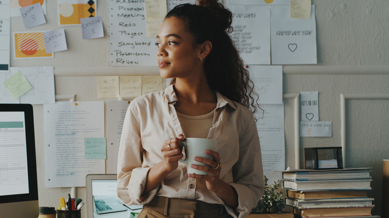 Woman working and drinking coffee