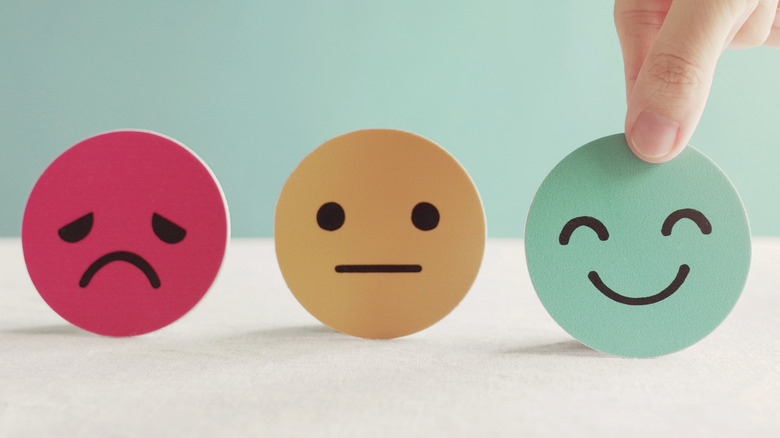 Sad, neutral, and happy emoji faces