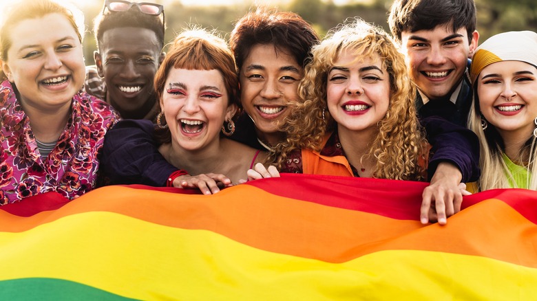 People smiling with pride flag