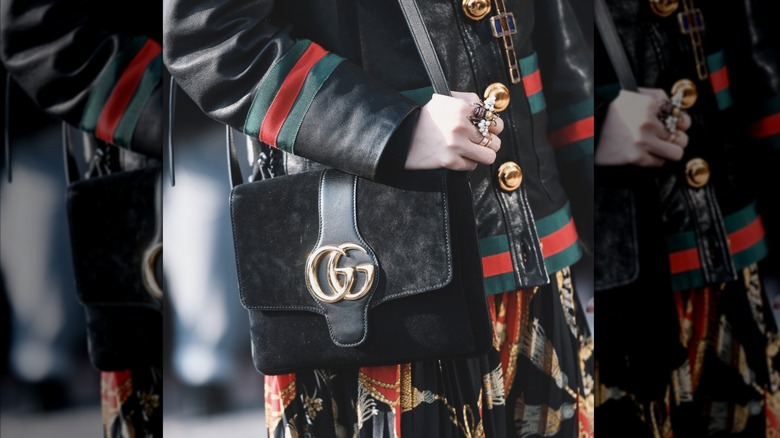 A woman over-accessorizing with items with loud logos